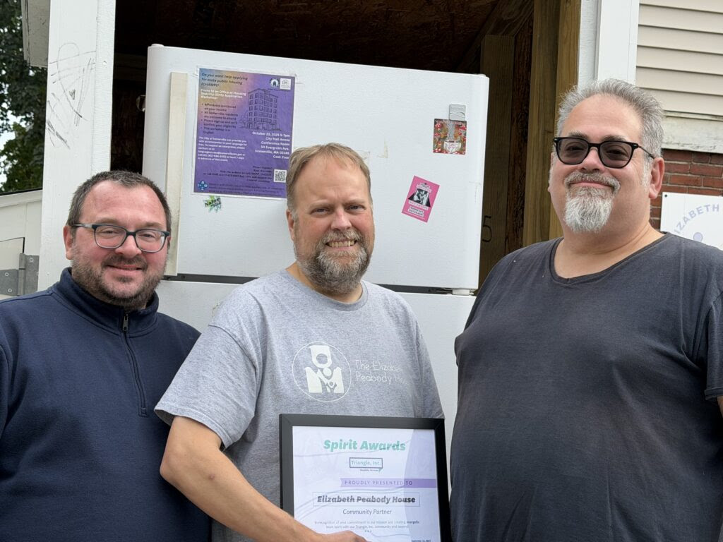 EPH Executive Director Matthew Caughey, Foods Access Program Director Thomas Boucher, and SNAP Coordinator/Food Pantry Associate with Community Partner Award in front of EPH Community Fridge